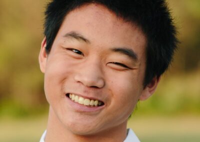 Christian Hall, Asian teenager smiling at camera