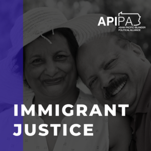 Grayscale photo of Desi couple smiling at the camera. Text on the photo says Immigrant Justice.