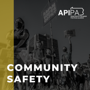 Grayscale photo of Asians at a protest. Yellow stripe. Text on graphic "Community Safety"