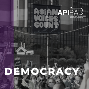Grayscale photo of a protest with a banner reading "asian voices count" waving above the crowd. Purple stripe. Text on Graphic reads "democracy"